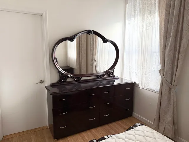 a living room with a table and a mirror