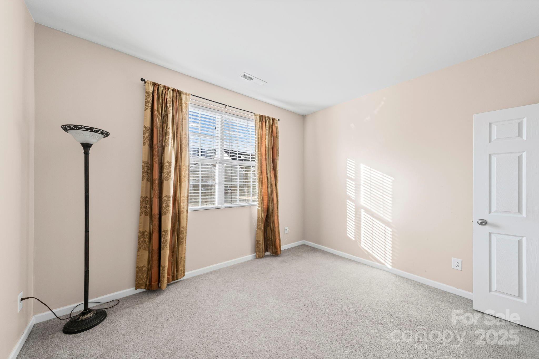 11608 Downy Birch Road Charlotte, NC 28227 - Photo 17 of 38 a view of empty room with windows