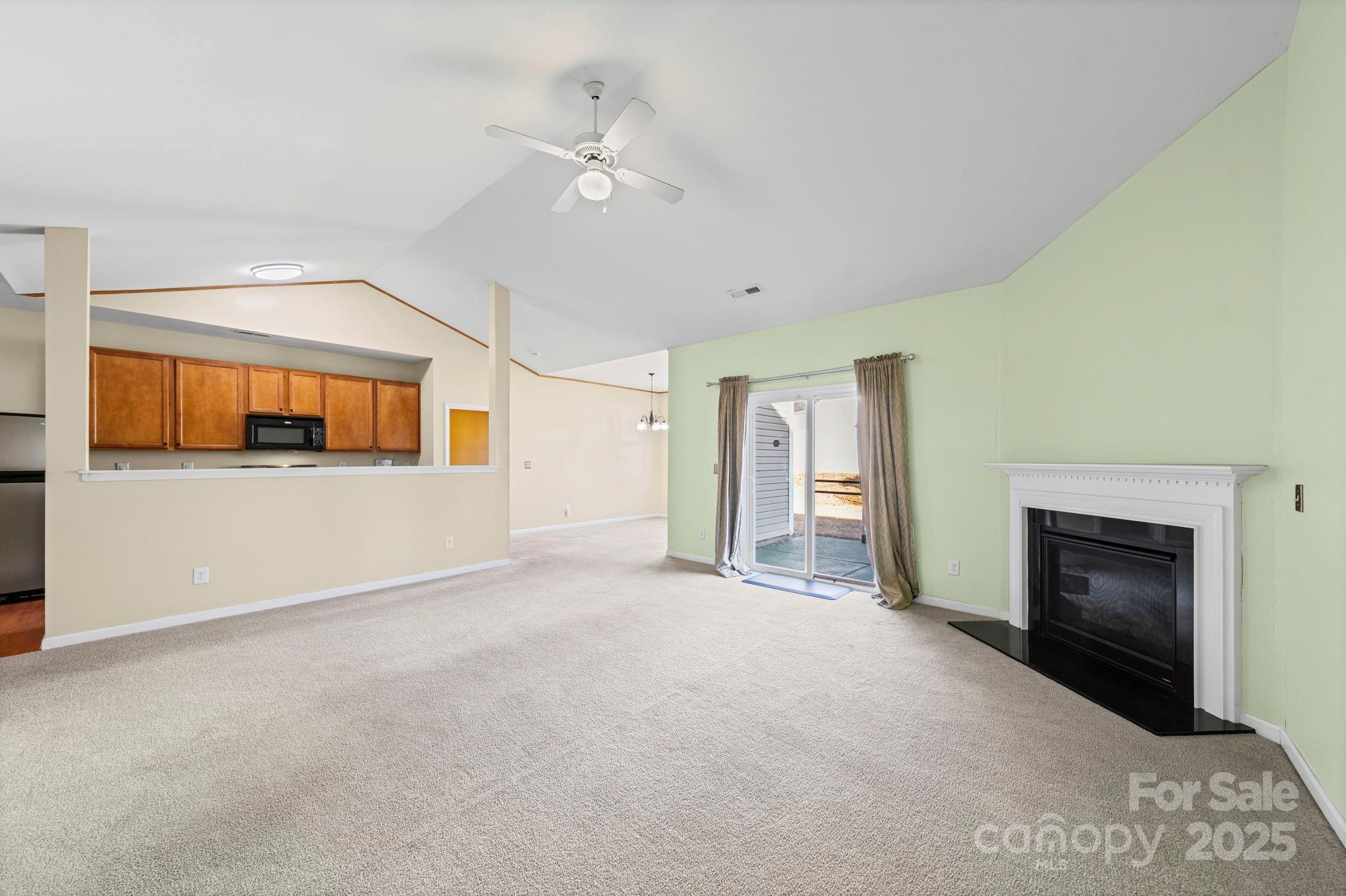 11608 Downy Birch Road Charlotte, NC 28227 - Photo 2 of 38 a view of an empty room with a fireplace and a window