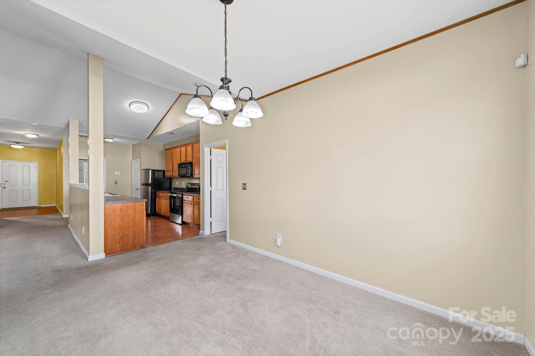 11608 Downy Birch Road Charlotte, NC 28227 - Photo 24 of 38 a view of a room with a chandelier