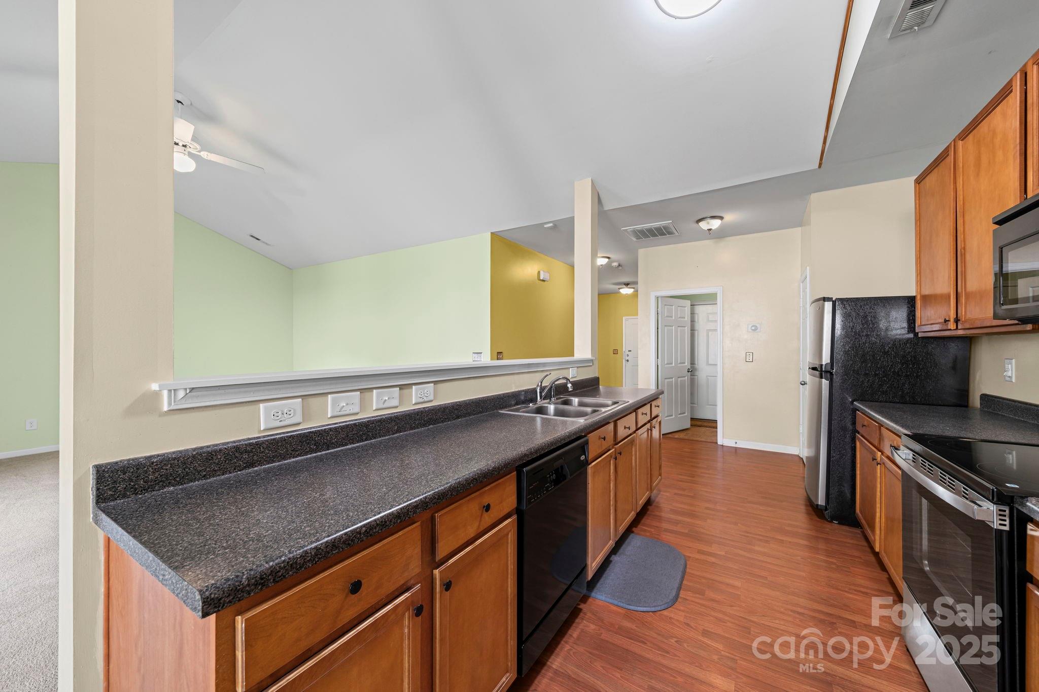 11608 Downy Birch Road Charlotte, NC 28227 - Photo 25 of 38 a kitchen with stainless steel appliances a sink stove and refrigerator