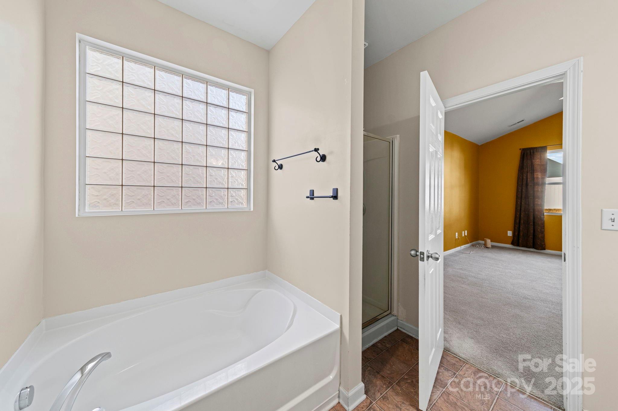 11608 Downy Birch Road Charlotte, NC 28227 - Photo 31 of 38 a bathroom with a bathtub and a shower