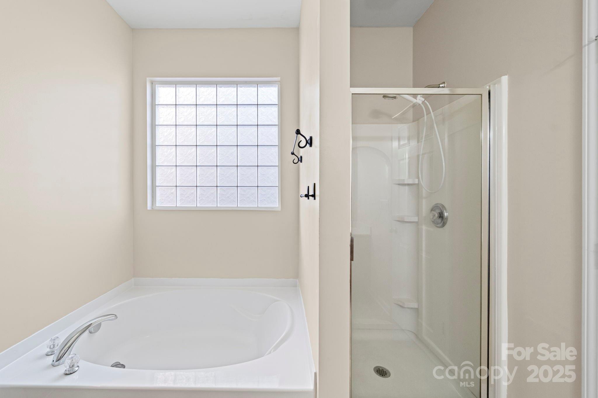 11608 Downy Birch Road Charlotte, NC 28227 - Photo 32 of 38 a white bath tub sitting next to a shower