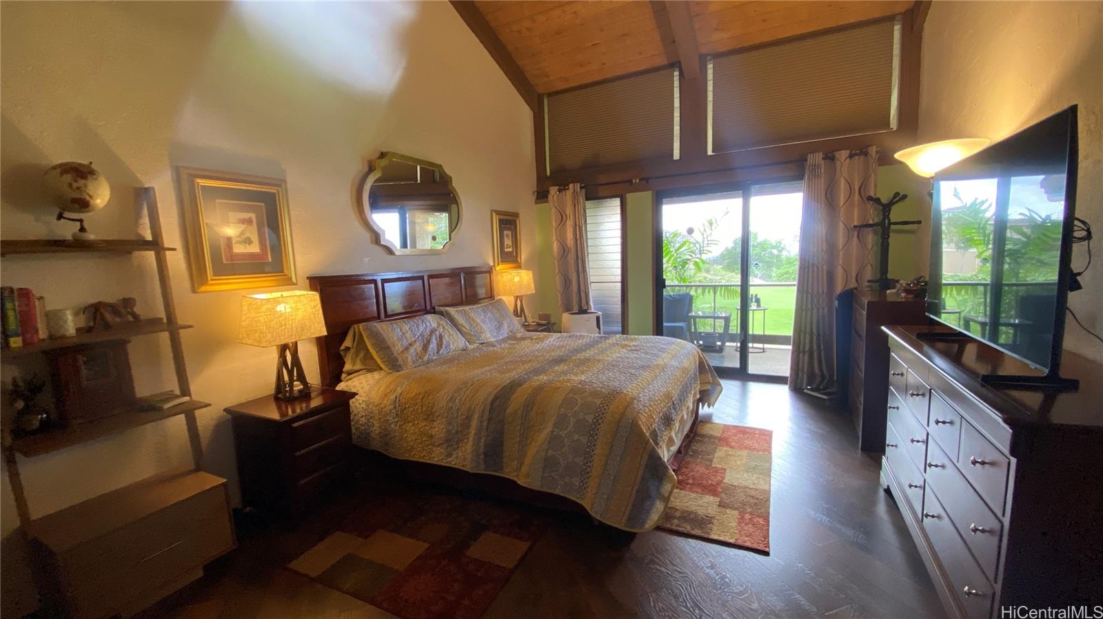 68-3840 Lua Kula Street, Unit E202 Waikoloa, HI 96738 - Photo 11 of 25 a spacious bedroom with a bed and wooden floor