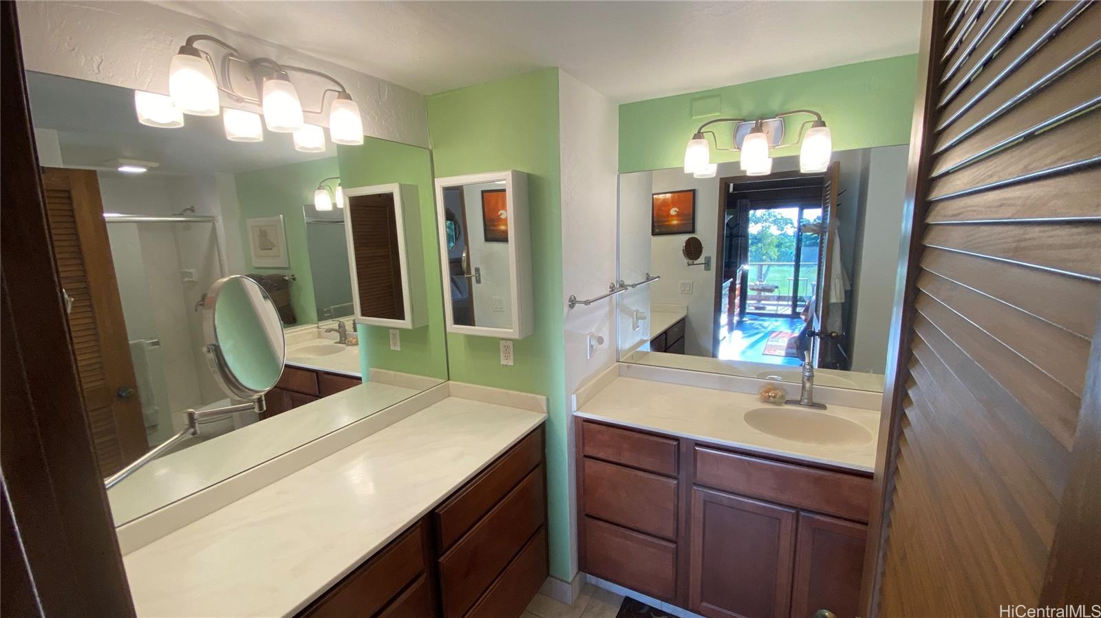 68-3840 Lua Kula Street, Unit E202 Waikoloa, HI 96738 - Photo 13 of 25 a bathroom with a sink a mirror and a shower