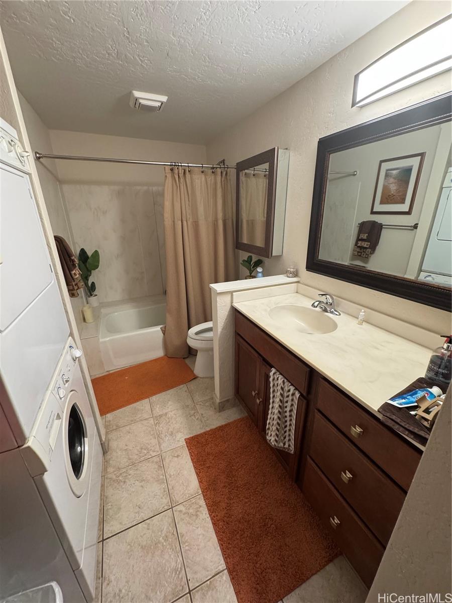 68-3840 Lua Kula Street, Unit E202 Waikoloa, HI 96738 - Photo 16 of 25 a bathroom with a sink a toilet a mirror and shower