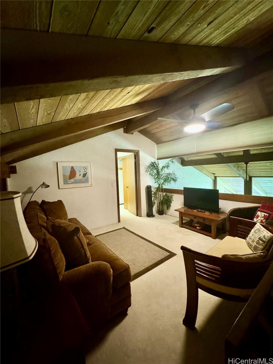 68-3840 Lua Kula Street, Unit E202 Waikoloa, HI 96738 - Photo 17 of 25 a living room with furniture and a black umbrella