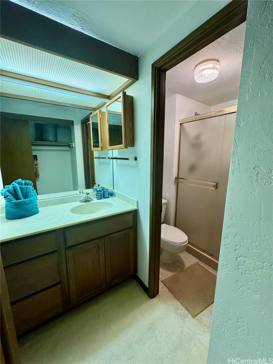 68-3840 Lua Kula Street, Unit E202 Waikoloa, HI 96738 - Photo 19 of 25 a bathroom with a sink and a mirror