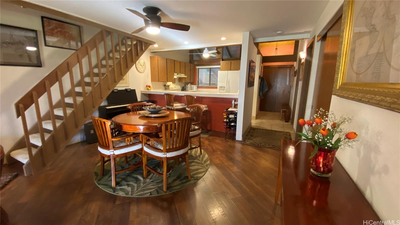 68-3840 Lua Kula Street, Unit E202 Waikoloa, HI 96738 - Photo 7 of 25 a dining room with furniture entryway and wooden floor