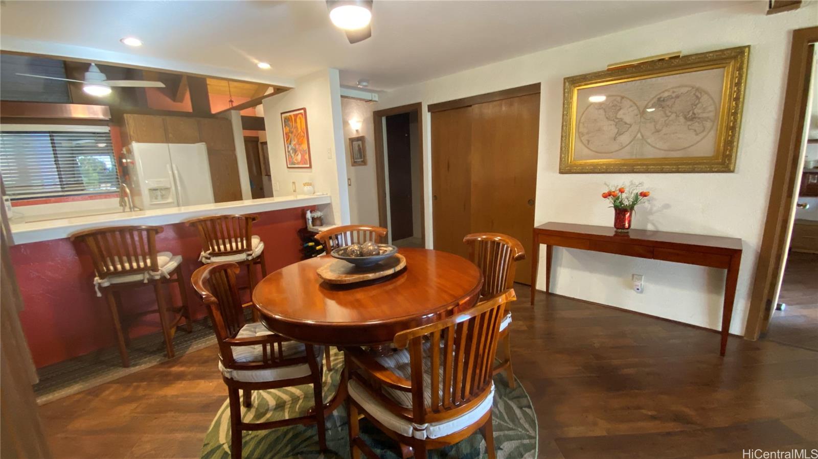 68-3840 Lua Kula Street, Unit E202 Waikoloa, HI 96738 - Photo 8 of 25 a view of a dining room with furniture and wooden floor