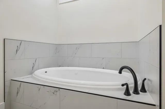 a house that has a big yard and a large tree in front of it