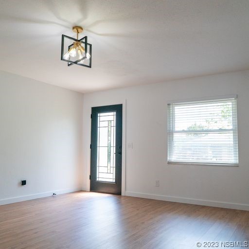 3219 Pine Tree Drive Edgewater, FL 32141 - Photo 12 of 13 a view of an empty room with wooden floor and a window