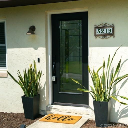 3219 Pine Tree Drive Edgewater, FL 32141 - Photo 2 of 13 a view of a glass door with a glass door