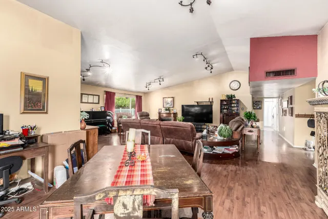 a living room with lots of furniture and painting on the wall