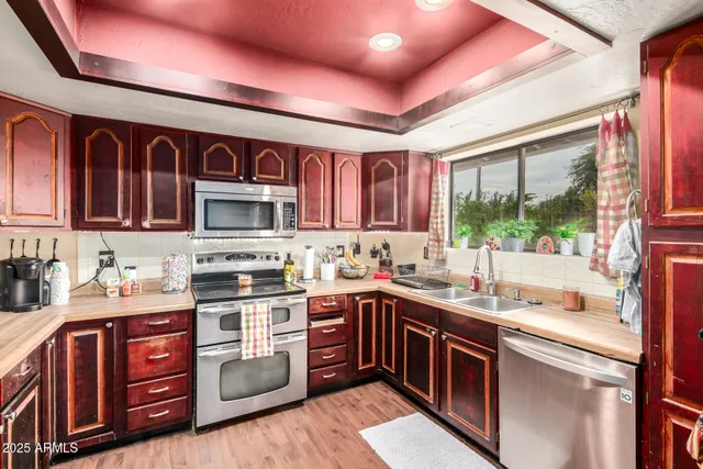 a kitchen with stainless steel appliances granite countertop a sink stove and cabinets