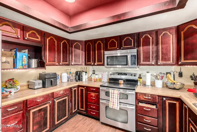 a kitchen with stainless steel appliances granite countertop a stove and cabinets