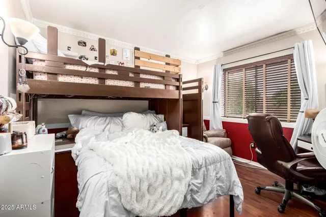 a bed sitting in a bedroom next to a window