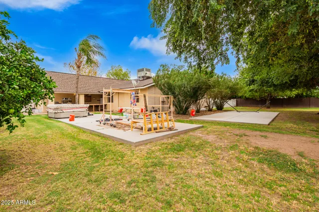a swimming pool with outdoor seating and yard
