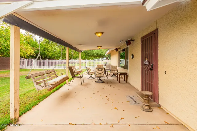 a view of a chairs and table in the balcony