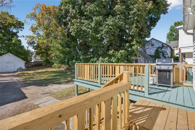 a view of a wooden deck and a backyard