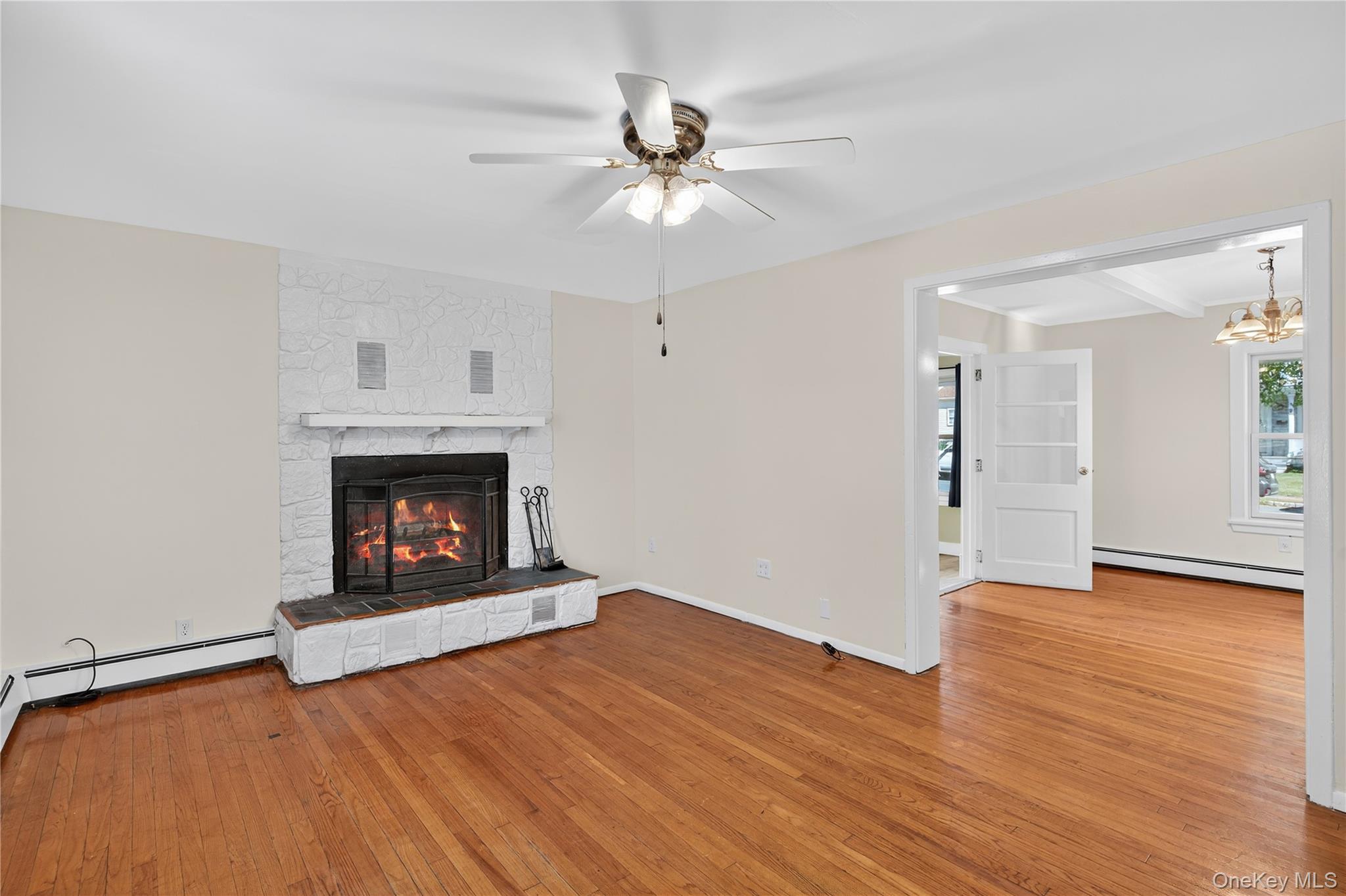 10 Howe Street Warwick, NY 10990 - Photo 17 of 33 a view of an empty room with wooden floor fireplace and a window