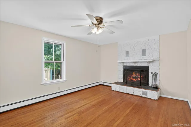 an empty room with windows and a fireplace