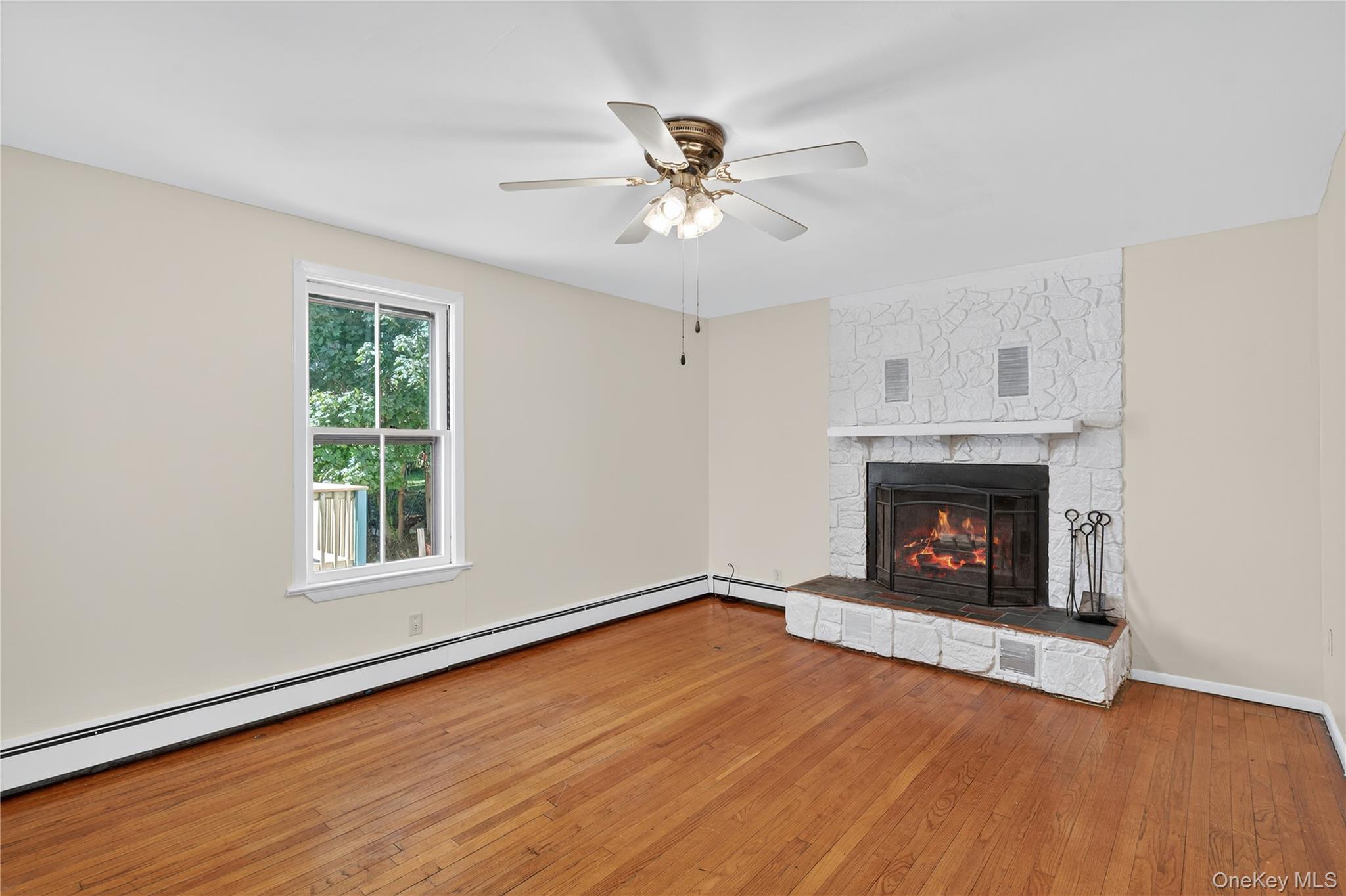 10 Howe Street Warwick, NY 10990 - Photo 18 of 33 an empty room with windows and a fireplace