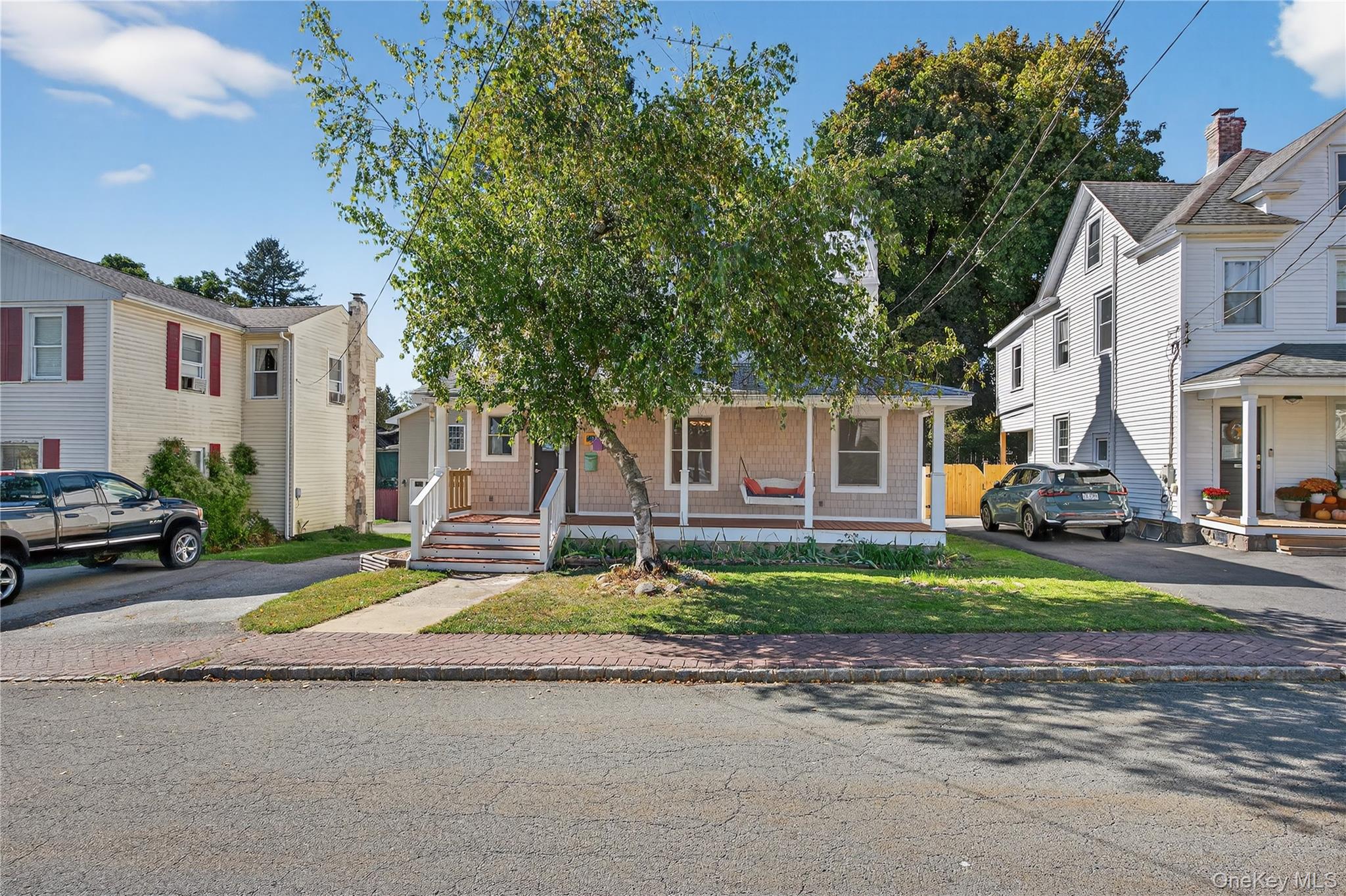 10 Howe Street Warwick, NY 10990 - Photo 2 of 33 a view of a white house with a patio and a yard