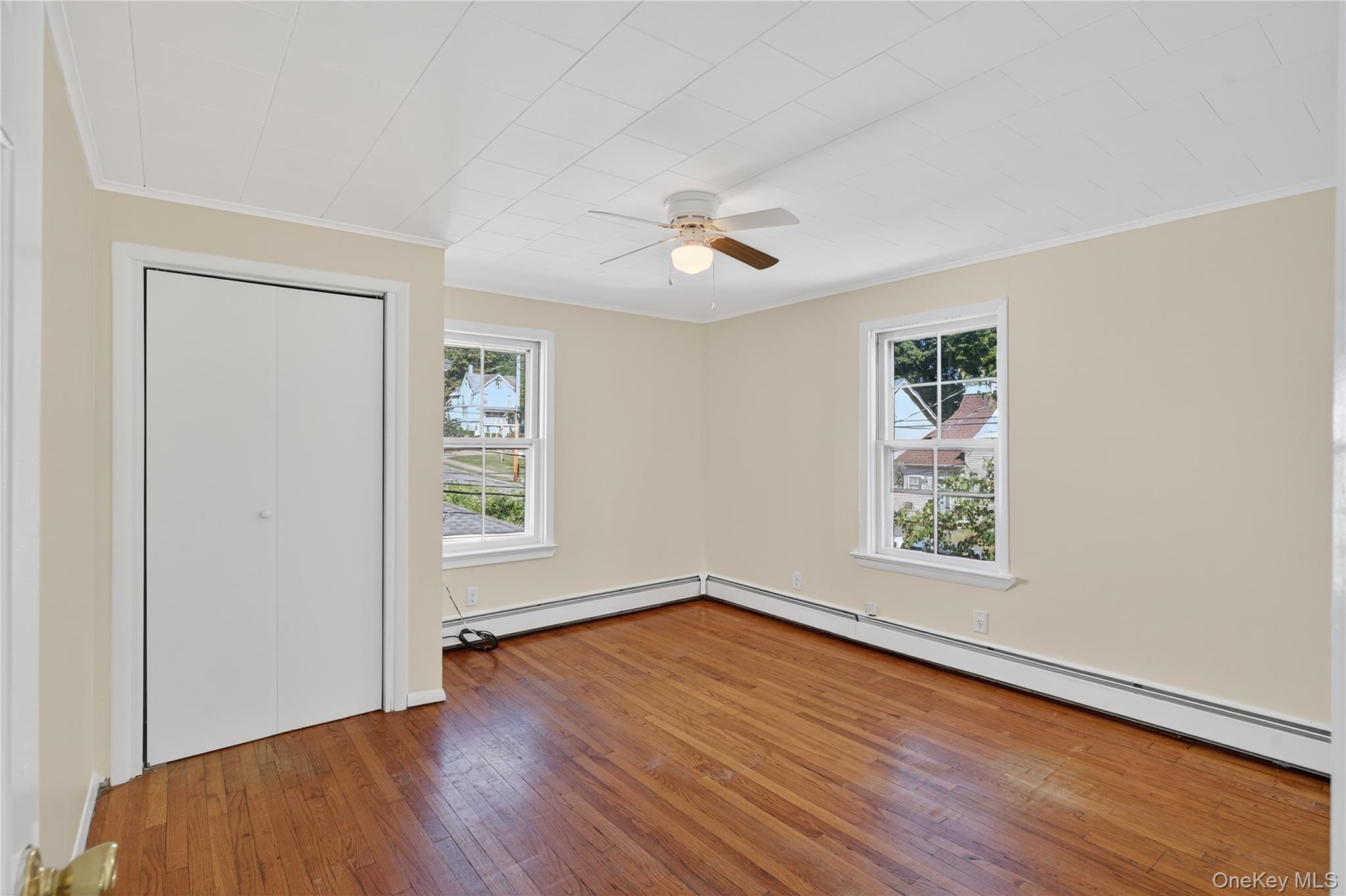 10 Howe Street Warwick, NY 10990 - Photo 24 of 33 a view of empty room with wooden floor and fan