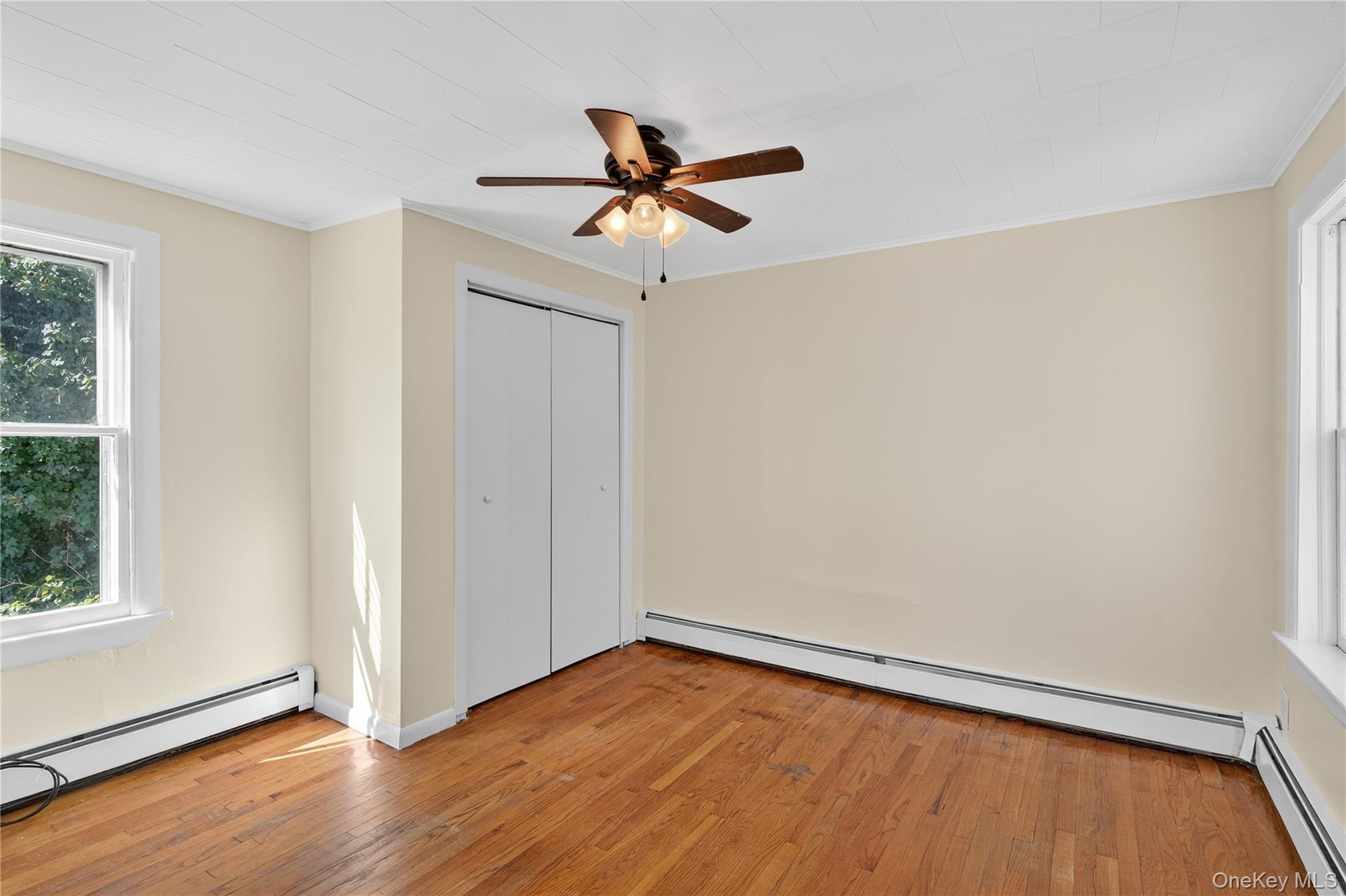 10 Howe Street Warwick, NY 10990 - Photo 28 of 33 a view of empty room with wooden floor and fan