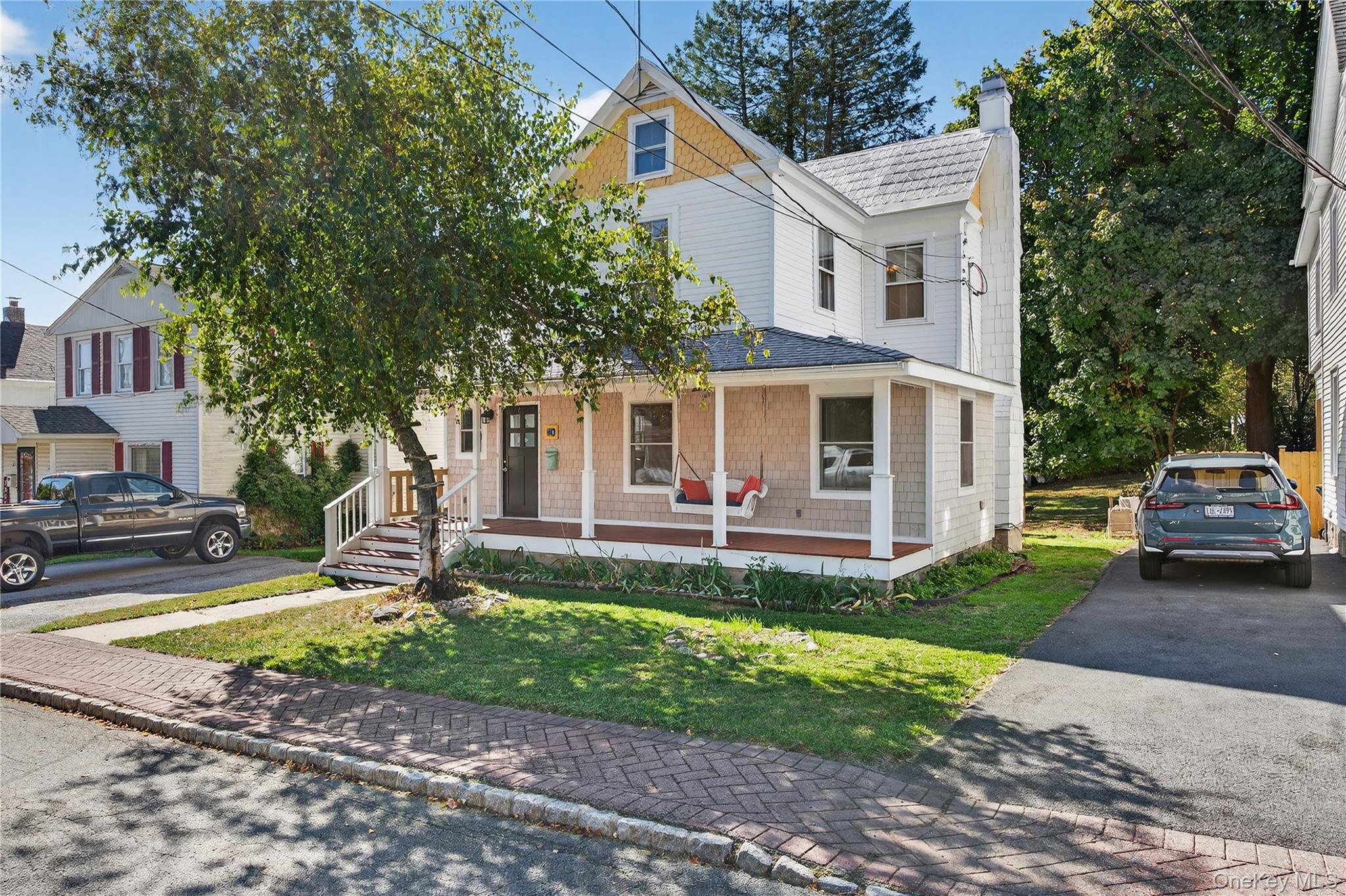 10 Howe Street Warwick, NY 10990 - Photo 3 of 33 a front view of a house with a yard table and chairs