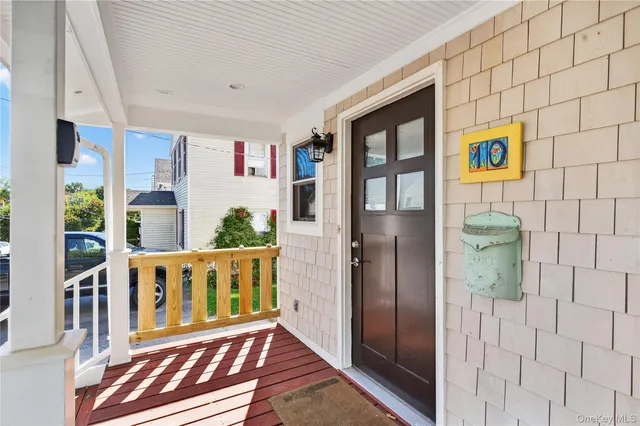 a view of a hallway with wooden floor and windows