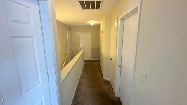 a view of a hallway with the wooden floor