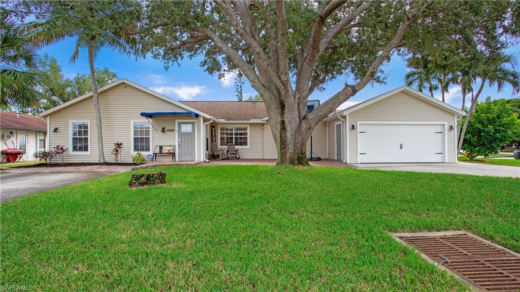 17269 Lee Road Fort Myers, FL 33967 - Photo 1 of 26 Single story home with a garage and a front lawn