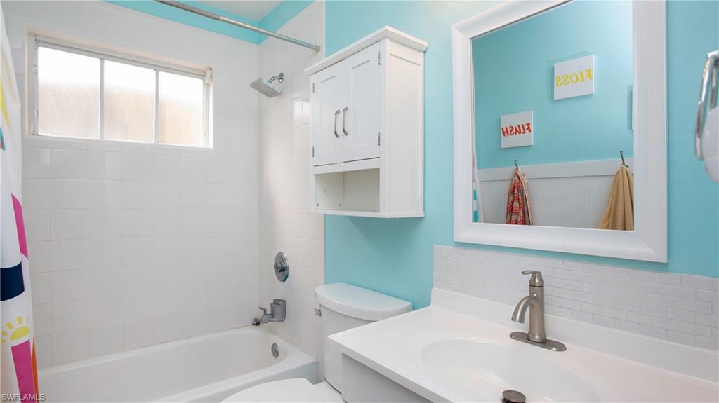 17269 Lee Road Fort Myers, FL 33967 - Photo 14 of 26 Full bathroom with vanity, toilet, and shower / bathtub combination with curtain