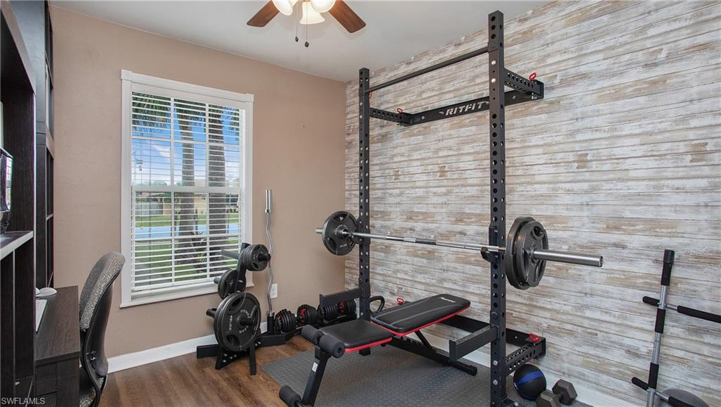 17269 Lee Road Fort Myers, FL 33967 - Photo 16 of 26 Workout area with a healthy amount of sunlight, hardwood / wood-style floors, and ceiling fan