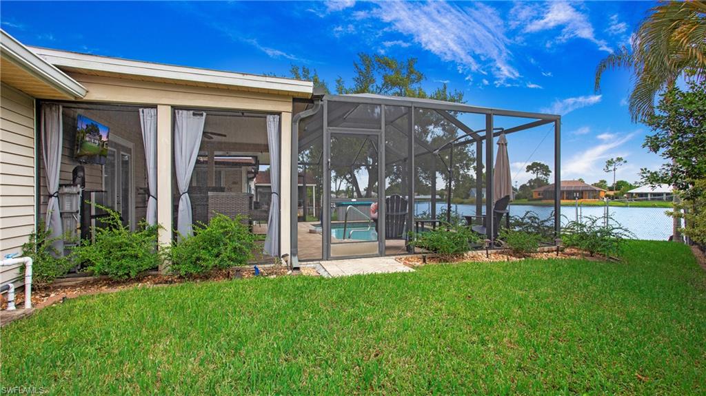 17269 Lee Road Fort Myers, FL 33967 - Photo 21 of 26 View of yard featuring glass enclosure and a water view