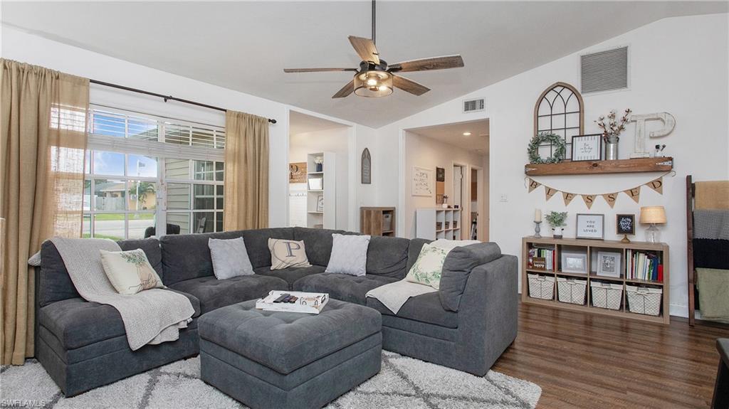 17269 Lee Road Fort Myers, FL 33967 - Photo 6 of 26 Living room featuring vaulted ceiling, ceiling fan, and hardwood / wood-style flooring