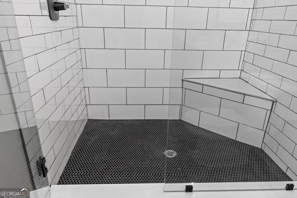 a bathroom with a granite countertop toilet sink and mirror