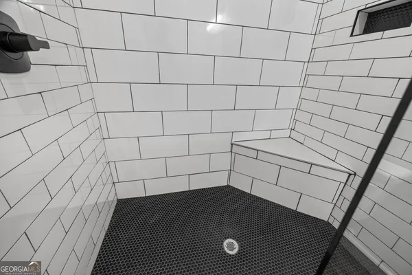 a bedroom with a bed and a rug