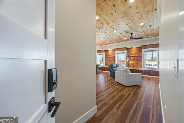 a living room with furniture and a floor to ceiling window