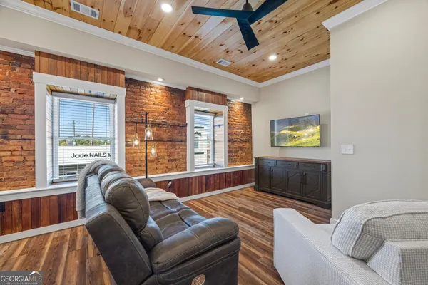 a living room with furniture and a flat screen tv