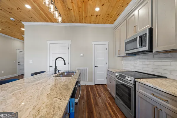 a stove top oven sitting inside of a kitchen
