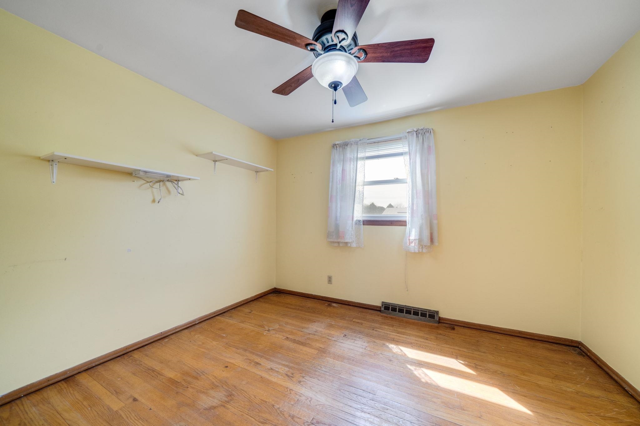 1611 Notre Dame Road Rockford, IL 61103 - Photo 12 of 33 an empty room with windows and fan