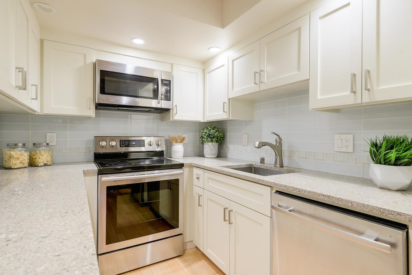 278 Monroe Drive, Unit 14 Mountain View, CA 94040 - Photo 8 of 20 a kitchen with white cabinets stainless steel appliances and sink