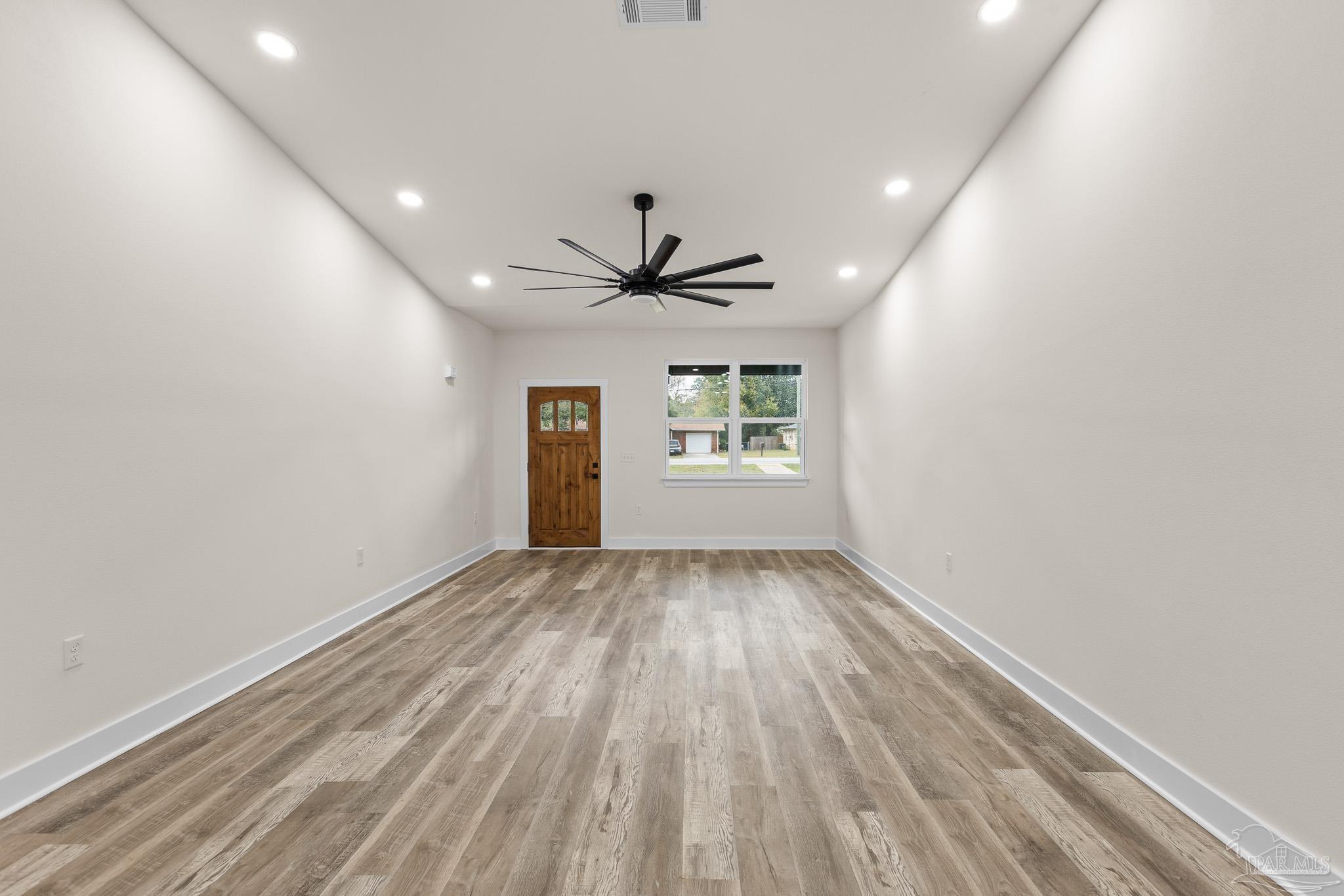 5005 Saufley Field Road Pensacola, FL 32526 - Photo 7 of 27 wooden floor in an empty room with a window