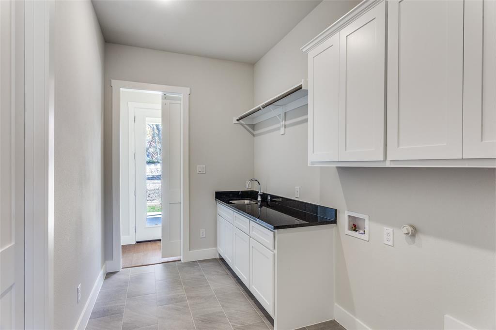 182 Fan Mill Trail Weatherford, TX 76085 - Photo 14 of 31 a kitchen with white cabinets and a stove
