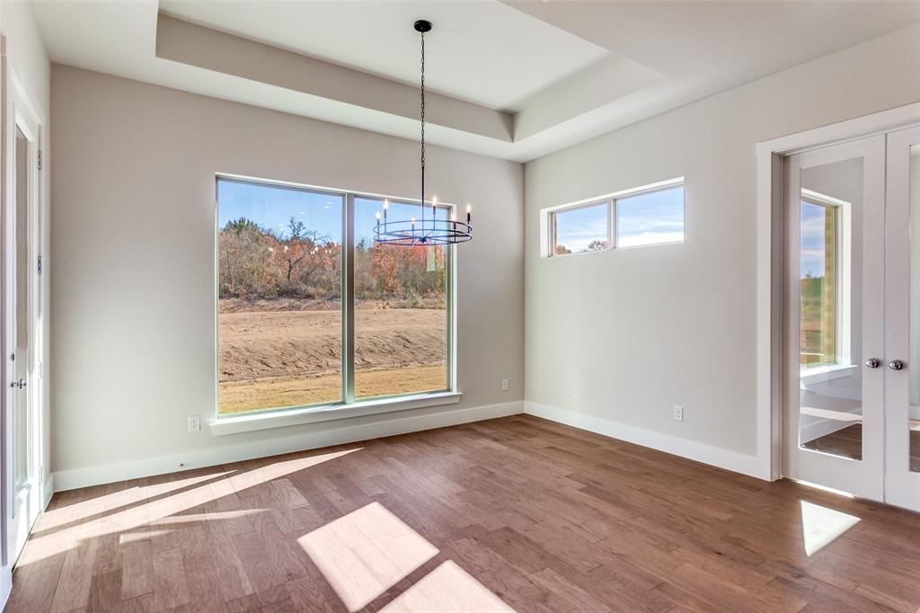 182 Fan Mill Trail Weatherford, TX 76085 - Photo 17 of 31 a view of an empty room with wooden floor and a window