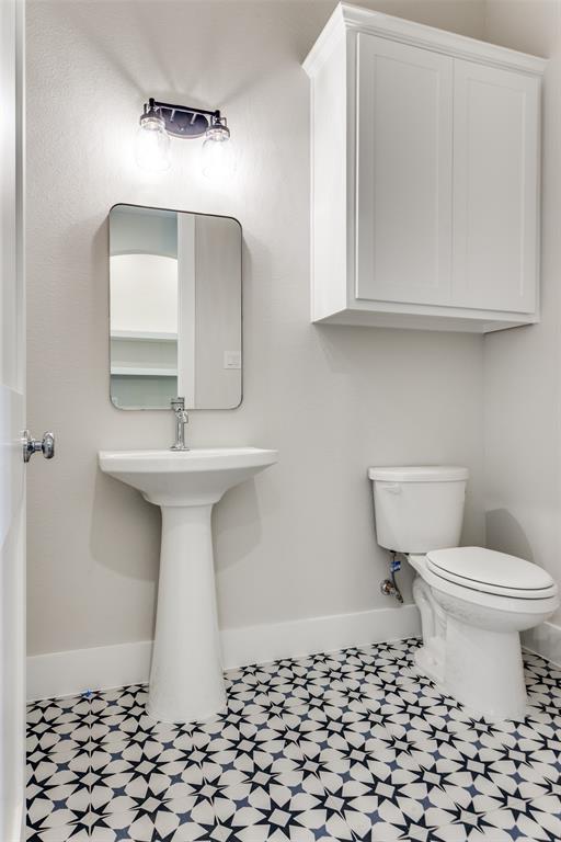182 Fan Mill Trail Weatherford, TX 76085 - Photo 22 of 31 a bathroom with a sink toilet and mirror