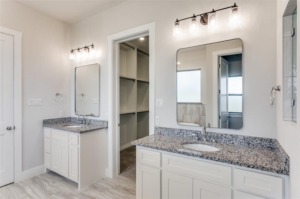 182 Fan Mill Trail Weatherford, TX 76085 - Photo 27 of 31 a bathroom with a granite countertop sink and a mirror